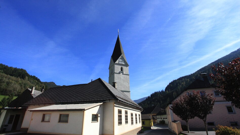 Kirche in Wald am Schoberpass umgeben von Straßen und vereinzelten Bäumen