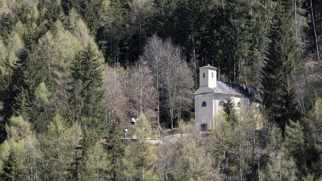 Eine kleine, weiße Kapelle steht zwischen dichten, grünen Wäldern. Die Umgebung ist ruhig und malerisch, ideal für Naturfreunde. | © Anita Fössl
