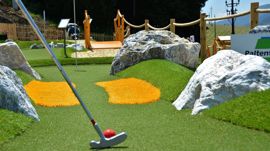 Eine Mini-Golfbahn mit künstlichem Gras, bunten Hindernissen und Felsen. Die Umgebung ist gut gestaltet und einladend für Spieler. | © Mountain Adventure Golf