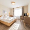Photo of FamilientageSommer., Junior suite, shower, toilet, living room/bedroom | © Hotel Grimmingblick