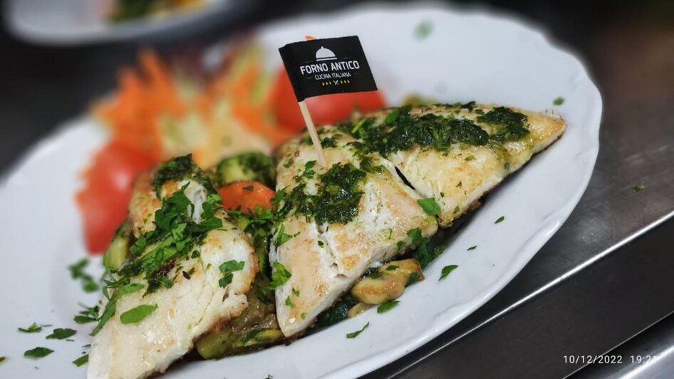 Gegrillter Fisch mit Kräutern und Beilagen im Forno Antico.